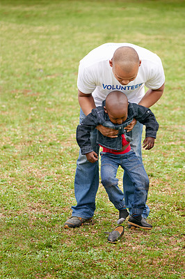 Buy stock photo Shot of a volunteer working with a little boy