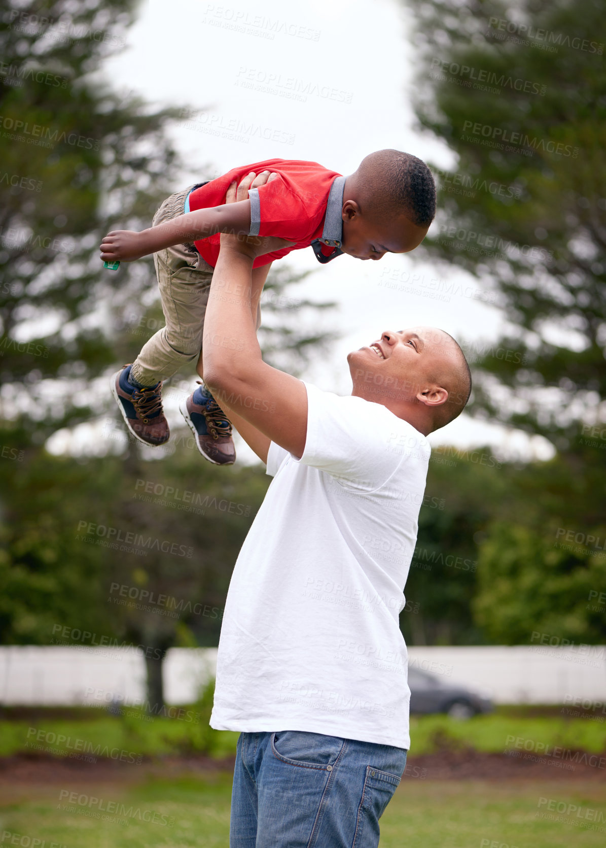 Buy stock photo Father, lifting and kid by playing in outdoor on grass with embrace, bonding and love for care in garden on vacation. Man, son and adventure in air for game, balance and childhood as airplane flying