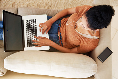 Buy stock photo Shot of an unrecognizable woman using a laptop at home