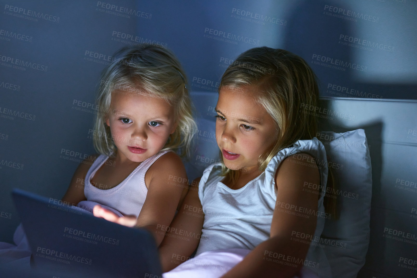 Buy stock photo Tablet, bedroom and kids in home at night for streaming movie, video and cartoon. Digital technology, girls and children in bed for game, learning and sisters reading story online to relax together