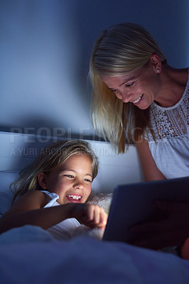 Buy stock photo Home, night and mama with girl, tablet and ebook for reading, bedroom and connection. Apartment, evening and family with mother, daughter and technology with digital app for story and love with humor