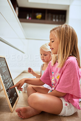 Buy stock photo Children, writing and chalkboard in home, list and group for help, teamwork or development in morning. Kids, blackboard or sisters on floor, chores schedule or planning for cleaning in family house