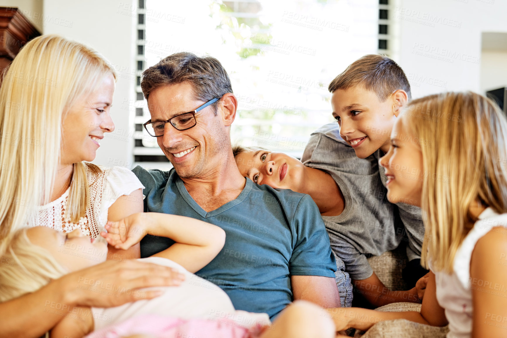 Buy stock photo Family, mother and father with children at home, relaxing and bonding together on weekend with happiness. House, dad and mom with kids for playful, connection and cheerful relationship with parents