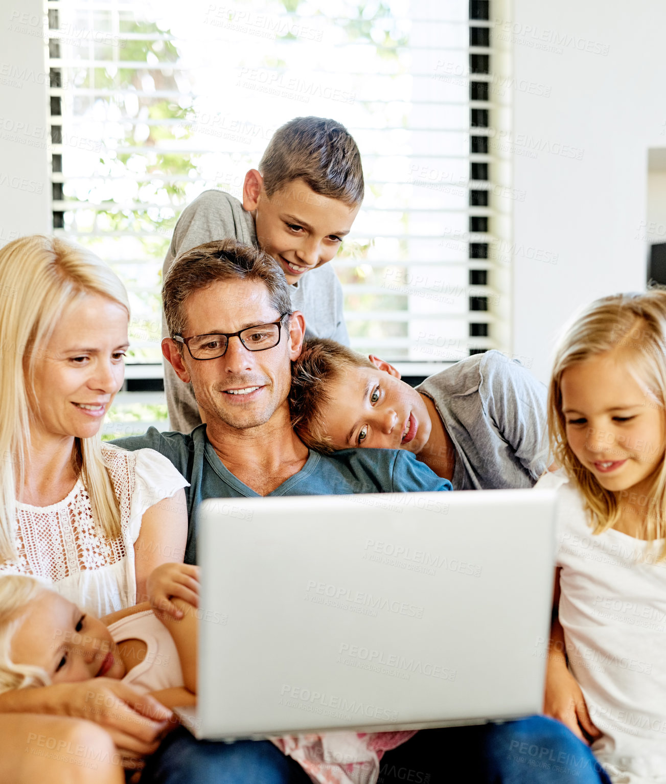 Buy stock photo Shot of a family using a laptop together at home