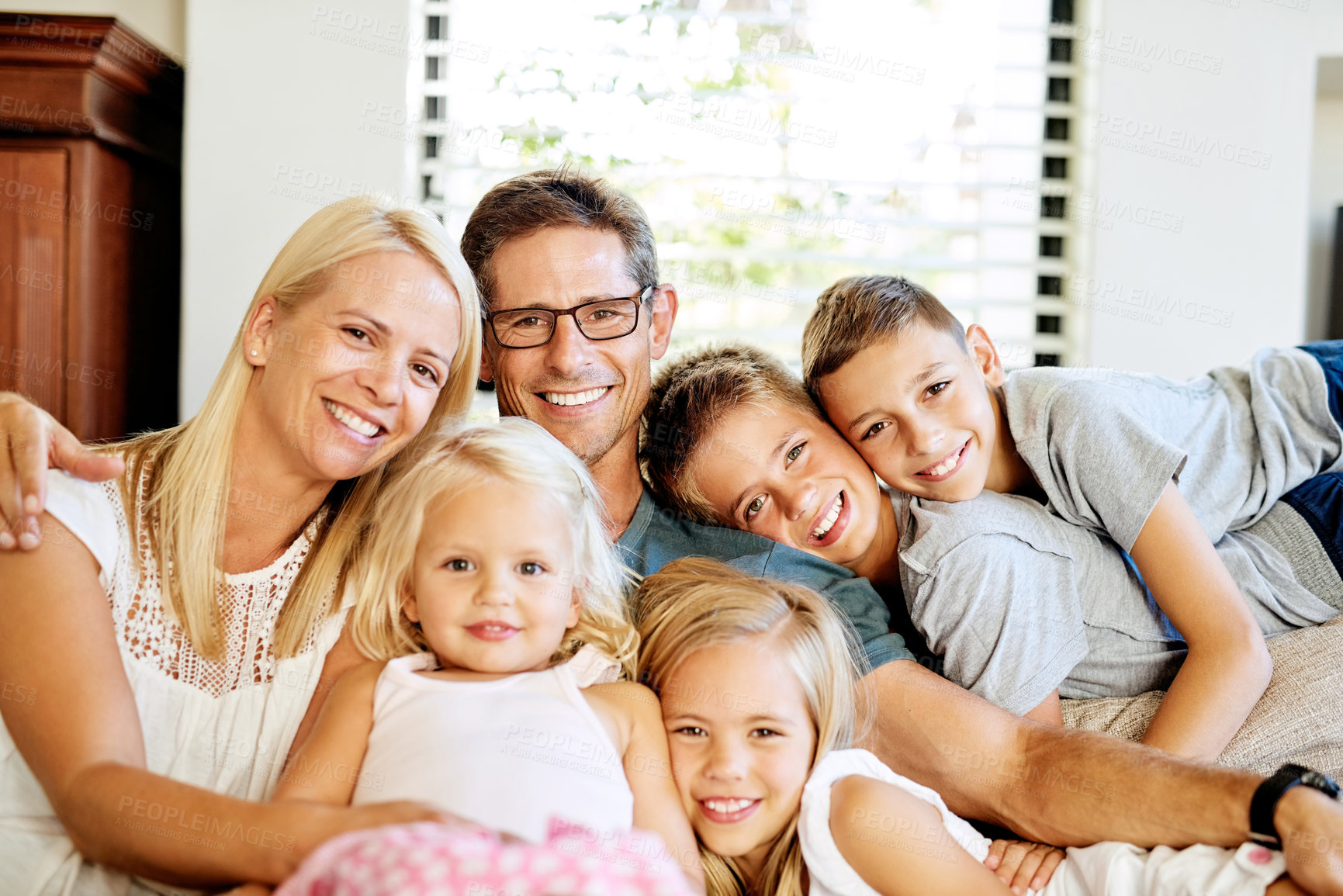 Buy stock photo Portrait of a happy family spending quality time together at home