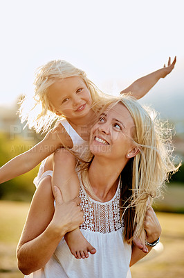 Buy stock photo Shot of a mother and her daughter playing outdoors