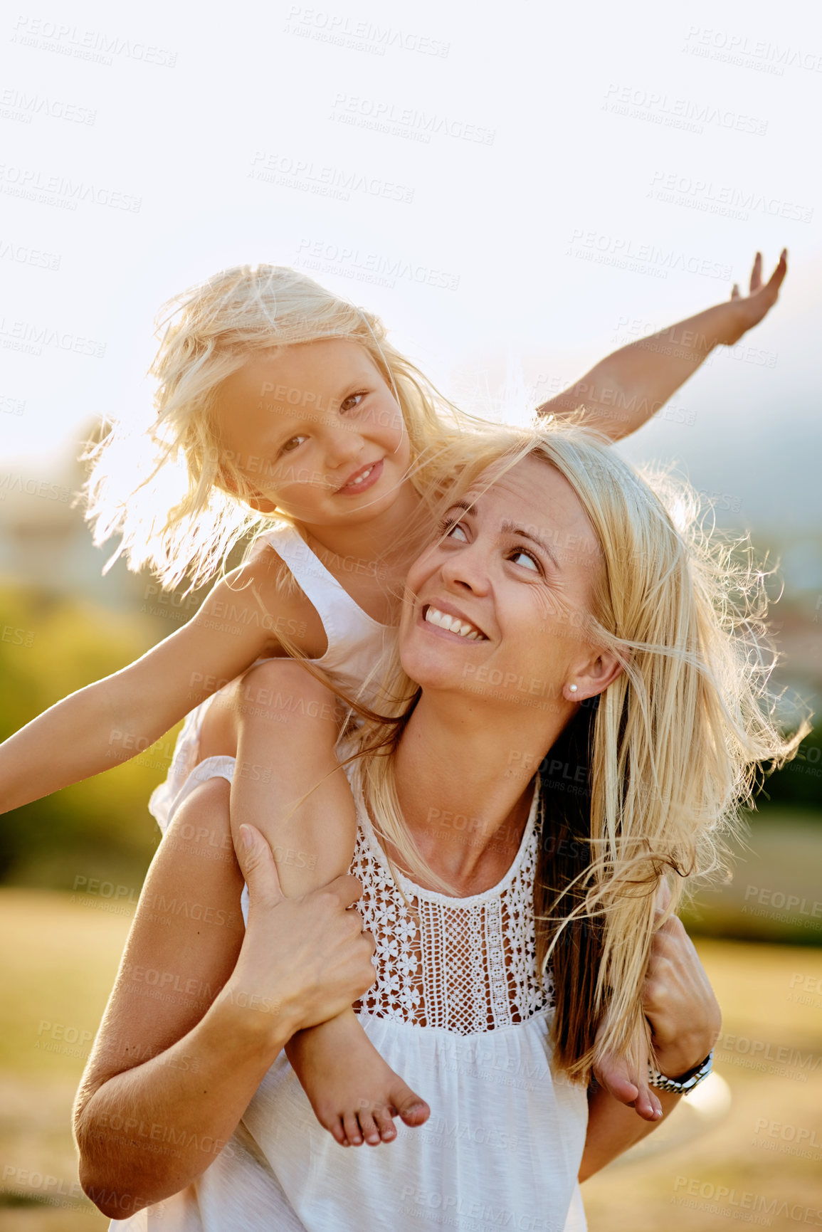 Buy stock photo Shot of a mother and her daughter playing outdoors