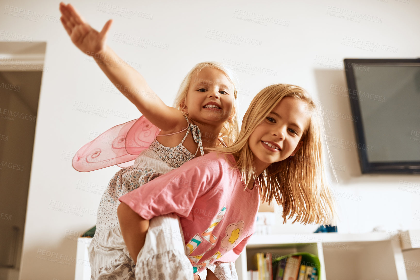 Buy stock photo Kids, piggyback and sisters in home for portrait, support and trust in relationship. Siblings, airplane or carry in living room with happiness, fantasy play and fun with bonding for growth in family