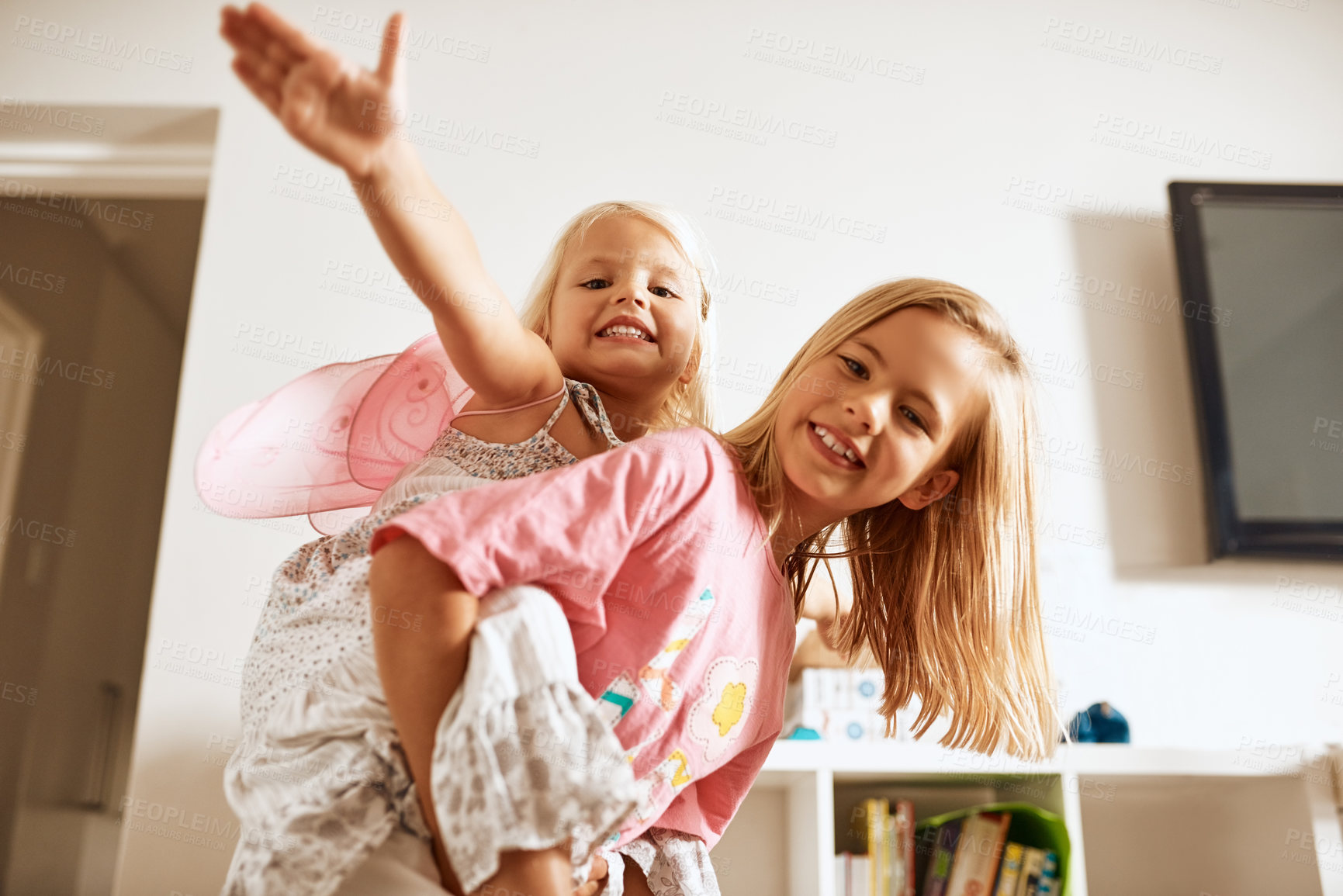 Buy stock photo Fly, piggyback and portrait of girls in home or fairy costume for dress up, fantasy play or tiara with smile. Family siblings, happy kids or sisters playing with wings or princess outfit for bonding