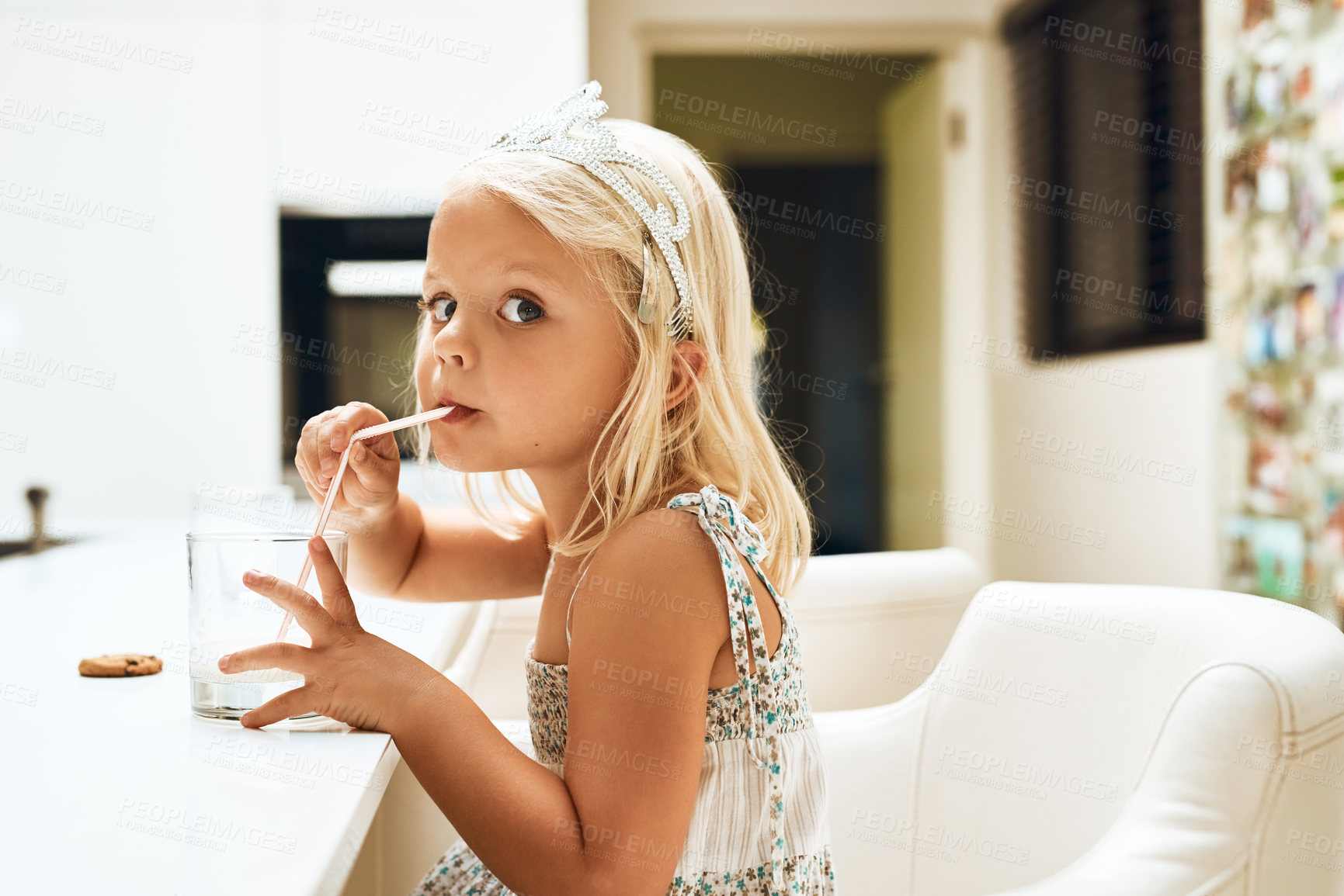 Buy stock photo Portrait of an adorable little girl drinking milk from a glass at home