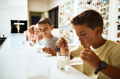 Buy stock photo Children, siblings and drinking with cookies in milk for snack, eat or sweet combination at home. Group of young kids with smile, meal or food for healthy calcium, beverage or amino acids in kitchen