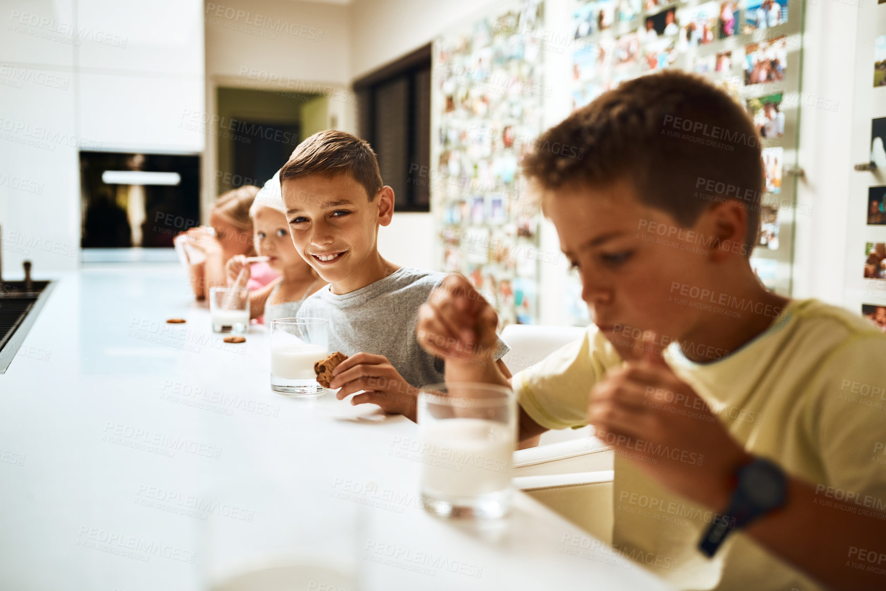 Buy stock photo Children, siblings and drinking with cookies in milk for snack, eat or sweet combination at home. Group of young kids with smile, meal or food for healthy calcium, beverage or amino acids in kitchen