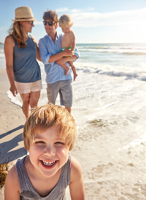 Buy stock photo Shot of a young family enjoying a summer day out at the beach