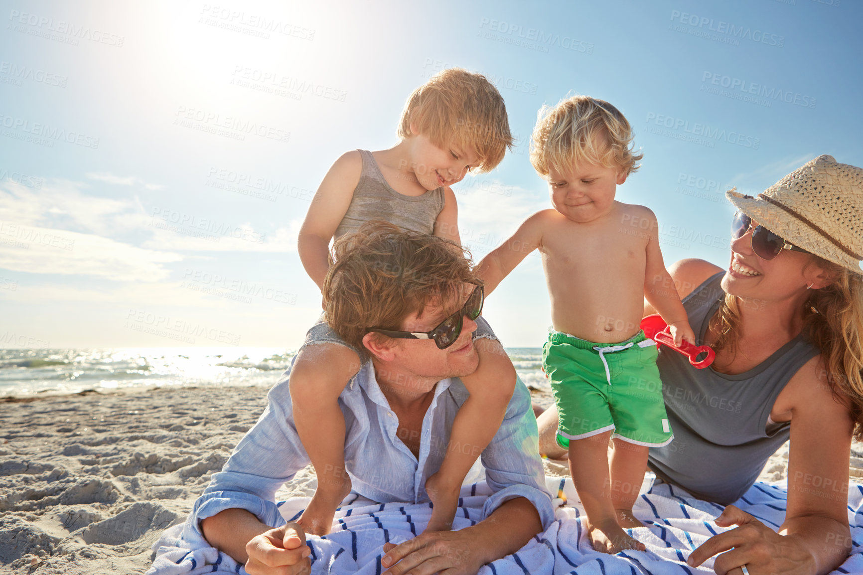 Buy stock photo Vacation, piggyback or kids with family at beach for holiday, summer or weekend together with parents. Father, mother or happy children siblings at sea for bonding, love or playing by ocean to relax