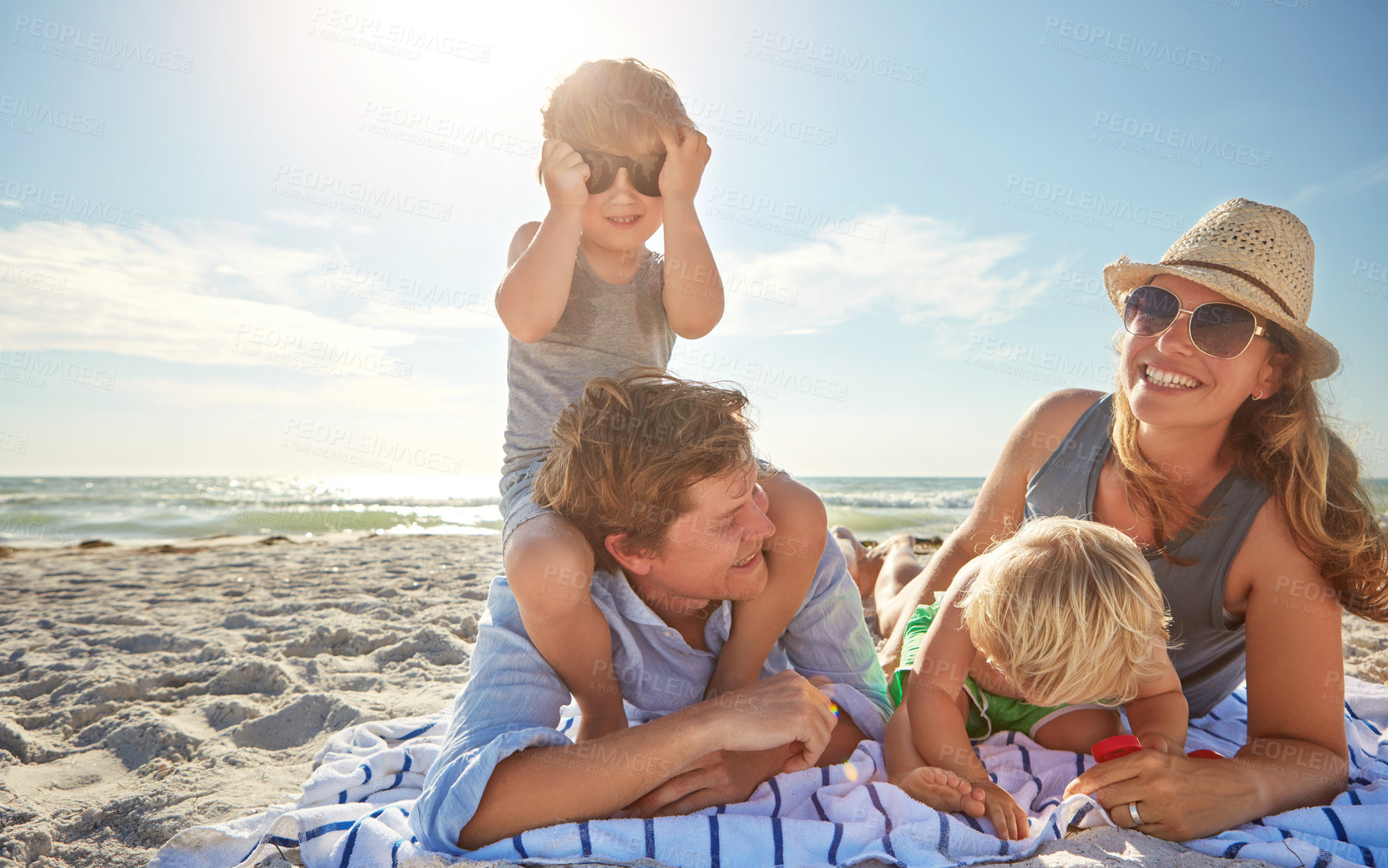 Buy stock photo Portrait, piggyback or children with family at sea for vacation, holiday or summer together with parents. Father, mother or happy kids siblings at beach for bonding, love or playing by ocean to relax