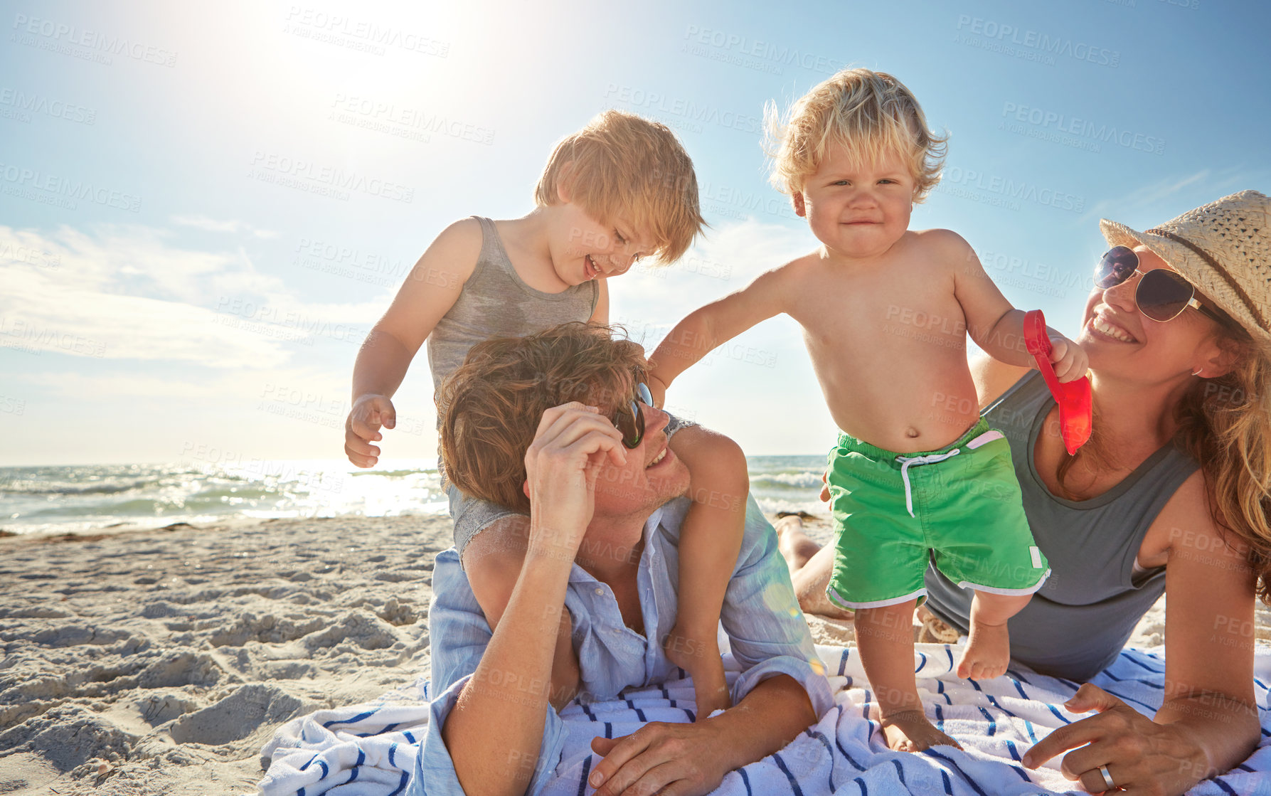 Buy stock photo Portrait, piggyback or kids with family at sea for vacation, holiday or summer together with parents. Father, mother or happy children siblings at beach for bonding, love or playing by ocean to relax