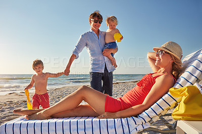 Buy stock photo Chair, relax or kids with parents at beach on holiday vacation or happy family weekend together. Father, fun mother or children siblings at sea for bonding or playing in nature in Spain in summer