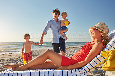 Buy stock photo Chair, relax or children with parents at beach on holiday vacation or happy family weekend together. Father, fun mother or kids siblings at sea for bonding or playing in nature in Spain in summer