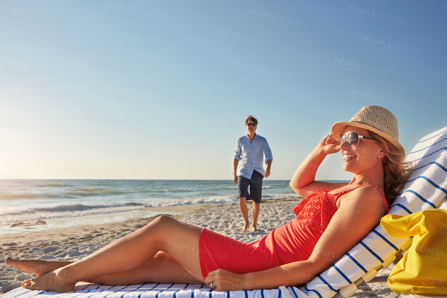 Buy stock photo Travel, couple and woman on chair at beach for sunshine, holiday and outdoor adventure together. Man, walking and smile with thinking by ocean for summer vacation, love and romantic honeymoon in Bali