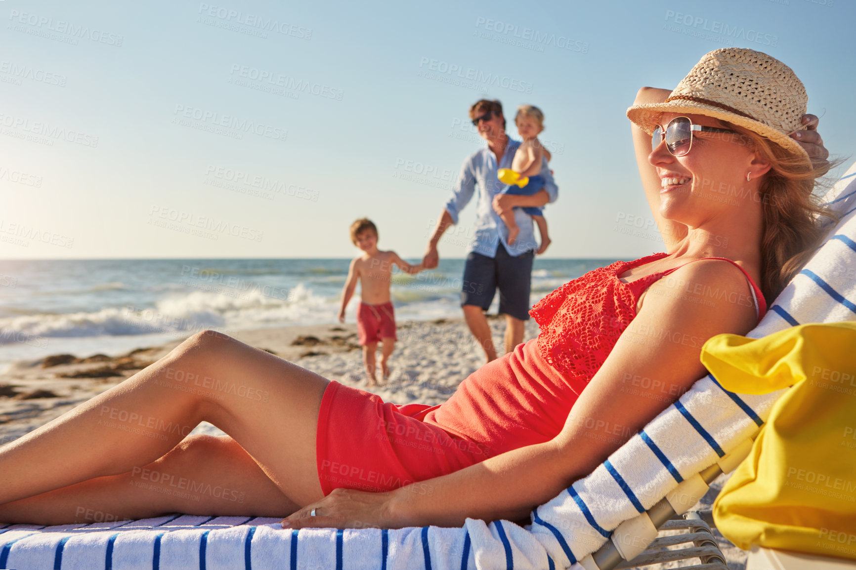 Buy stock photo Chair, relax or family with mom at beach on holiday vacation or weekend together with dad or children. Father, fun mother or kids siblings at sea for bonding or break in nature in Spain in summer