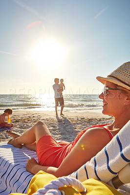 Buy stock photo Woman, happy and relax on beach chair with family together, adventure and bonding in summer. Blue sky, mother and father and kids in sunshine by ocean for travel for tropical vacation in Bali

