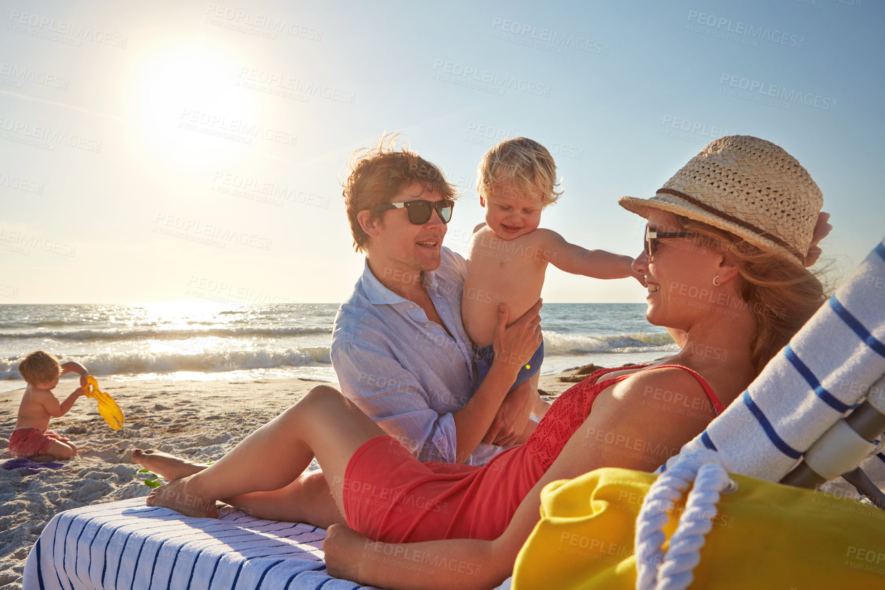 Buy stock photo Woman, man and kids on beach bed as family on holiday, vacation in Istanbul for happiness or memory. Excited, people and ocean for relax, together or bonding as parents in growth, development or play