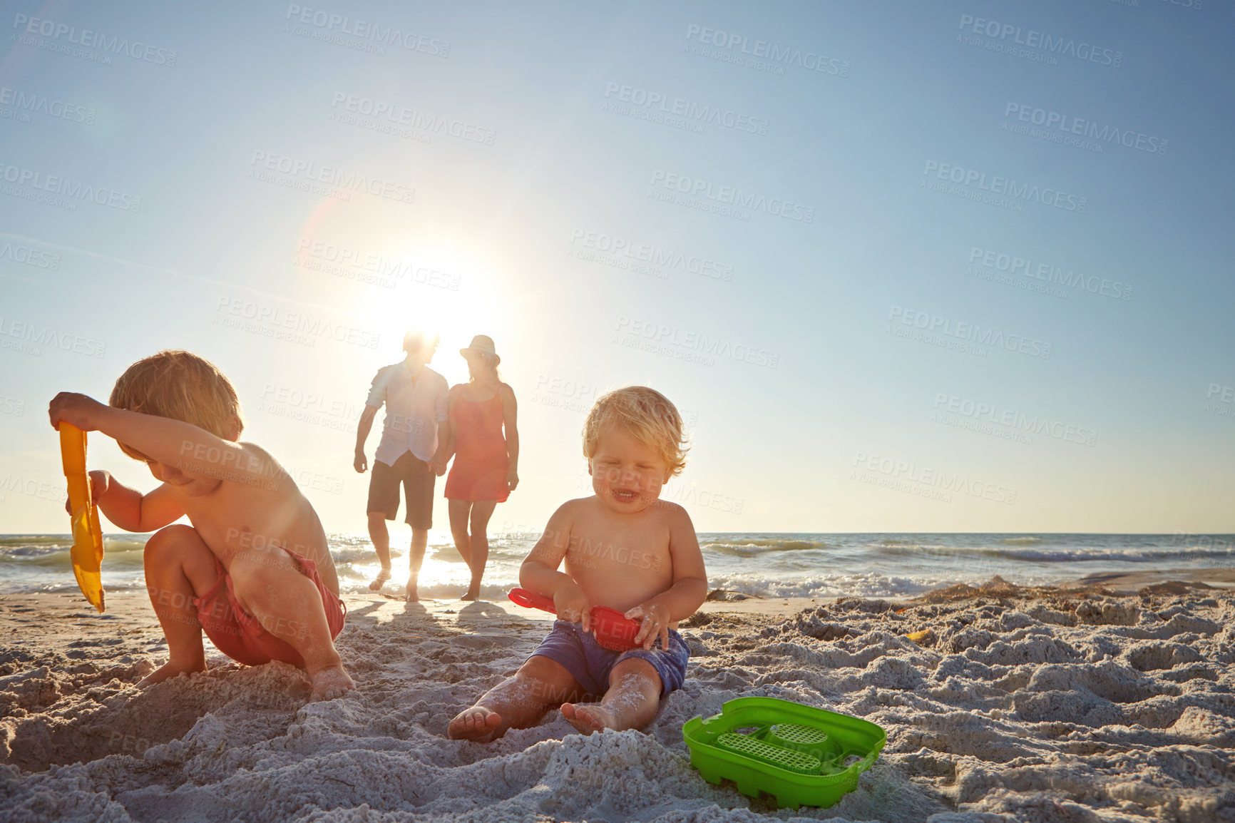 Buy stock photo Happy, family and children with sand castle on beach for holiday, travel or vacation together. Mother, father and kids outdoor in summer on tropical island coast for adventure, bonding or development