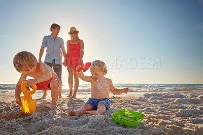 Buy stock photo Blue sky, family and children with sand castle ob beach summer for holiday, travel or vacation together. Mom, dad and kids outdoor in summer on tropical coast for adventure, bonding or development