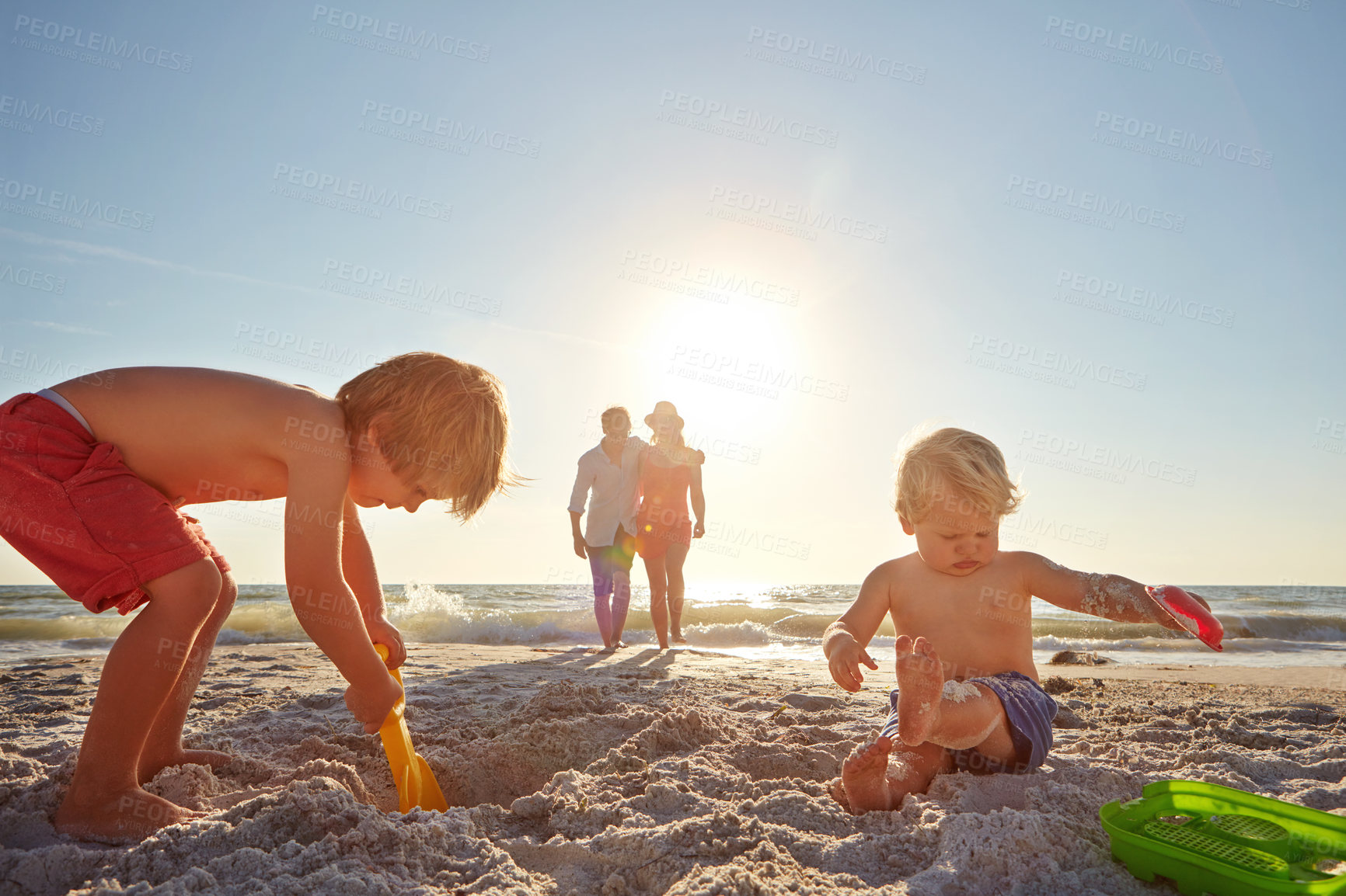 Buy stock photo Summer, family and children with sand castle on beach for holiday, travel or vacation together. Mother, father and kids outdoor for development, playing or weekend bonding on tropical island coast