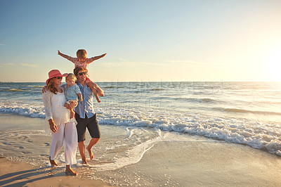 Buy stock photo Happy family, beach holiday and walking, smile for vacation on tropical island. Man, woman and children together with sunglasses by ocean for travel with wellness, mockup space at sunset in Mauritius