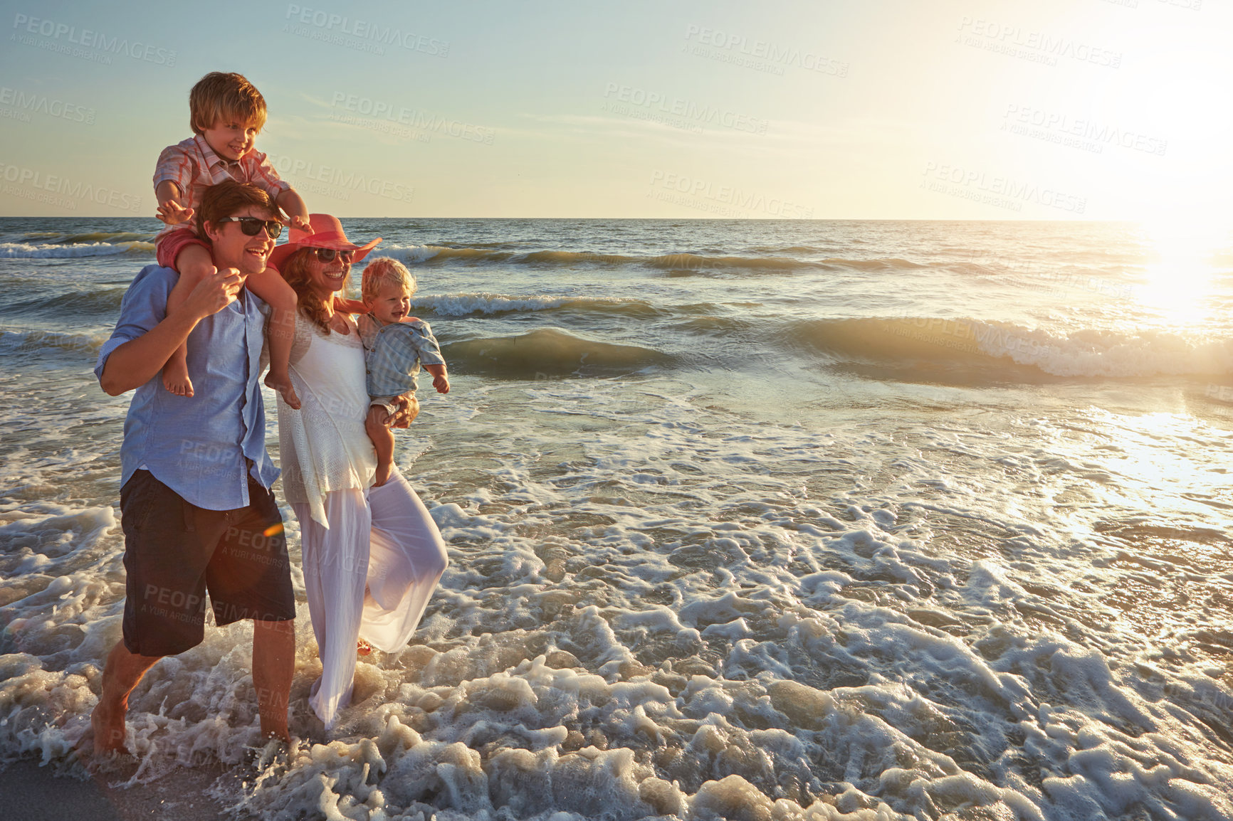 Buy stock photo Family, beach holiday and love, happiness for vacation on tropical island. Man, woman and children together with sunglasses by ocean for travel with wellness, mockup space at sunset in Mauritius