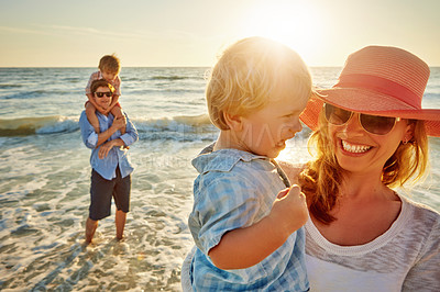 Buy stock photo Happy family, mother and beach with child for bonding, outdoor holiday or weekend in sunset or nature. Mom, father and children with smile for embrace, love or care in sunshine by ocean coast or sea