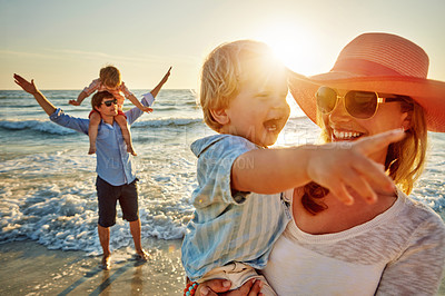 Buy stock photo Happy family, mother and beach with little boy for bonding, outdoor holiday or weekend in nature sunset. Mom, father or children with smile for embrace, love or care in sunshine by ocean coast or sea