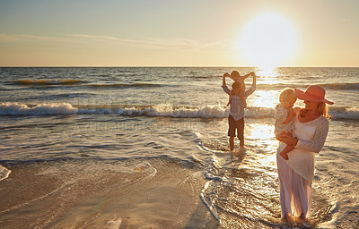 Buy stock photo Family, parents and beach with children in sunset for bonding, outdoor holiday or weekend in nature. Mom, father or kids playing together for embrace, love or care in sunshine by ocean coast or sea