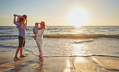 Buy stock photo Family, parents and beach with children for bonding, outdoor holiday or weekend in nature or sunset. Mom, father or kids playing together for embrace, love or care in sunshine by ocean coast or sea