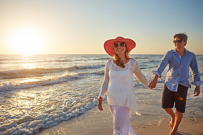 Buy stock photo Morning, couple and walking in beach, outdoor and happiness for vacation, holding hands and holiday in Florida. Trip, man and woman in honeymoon, pregnant and bonding in sea, date or together on sand