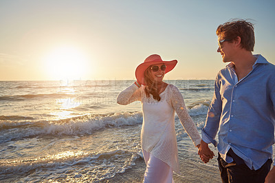 Buy stock photo Couple, man and woman on beach trip for holiday fun, vacation and adventure with love. Relationship, male person and partner on seashore walking with sunset for summer travel, support and wellness