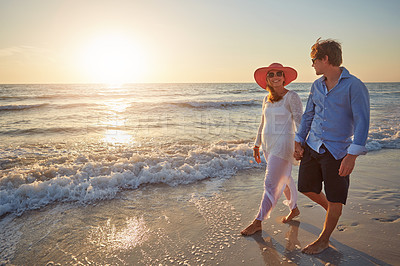 Buy stock photo Holding hands, couple and walking in beach, outdoor and happiness for vacation, romance and holiday in Florida. Trip, man and woman in honeymoon, smile and bonding in date, sea and together on sand