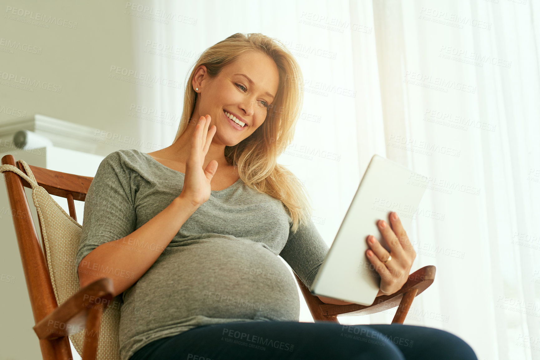 Buy stock photo Pregnant, woman and video call with tablet, greeting and smile for medical appointment and telehealth. Home, wave and happy for virtual prenatal, talk and health of baby, online or checkup for person