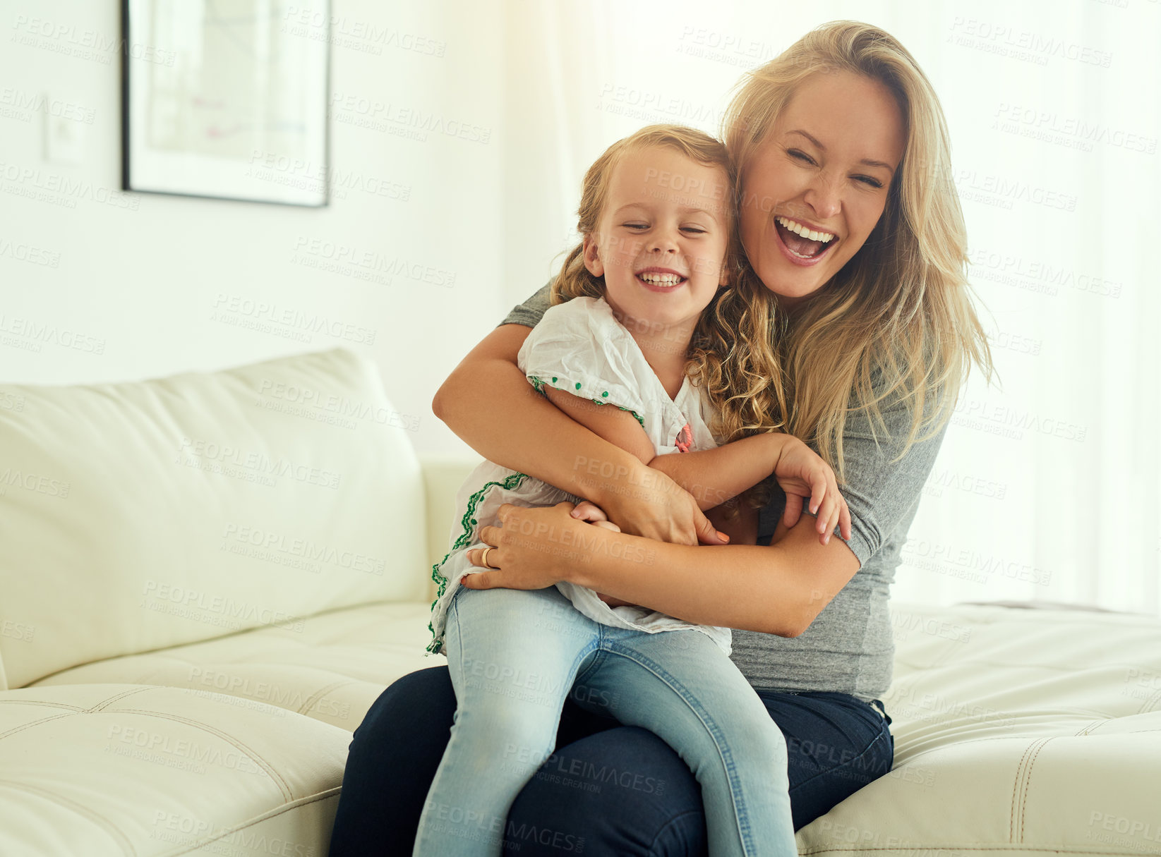 Buy stock photo Mom, girl and playing in home with hug, funny daughter or smile on couch to relax as happy family. Single parent, laughing or child in house with mother, youth development or care for bonding or love