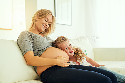 Buy stock photo Shot of a little girl listening to her mother's pregnant belly