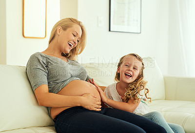 Buy stock photo Shot of a pregnant woman spending time with her little girl