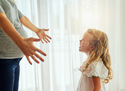 Buy stock photo Cropped shot of a pregnant woman reaching out for her little girl