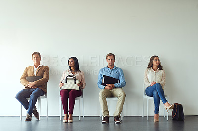 Buy stock photo Shot of a diverse group of people sitting in a row while waiting for a chance to interview