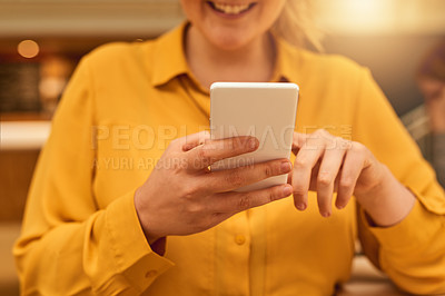 Buy stock photo Cropped shot of an unidentifiable businesswoman using her smartphone in the office