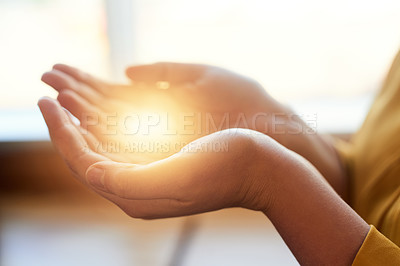Buy stock photo Cropped shot of an unidentifiable businesswoman cupping a glowing cgi element in her hand in the office