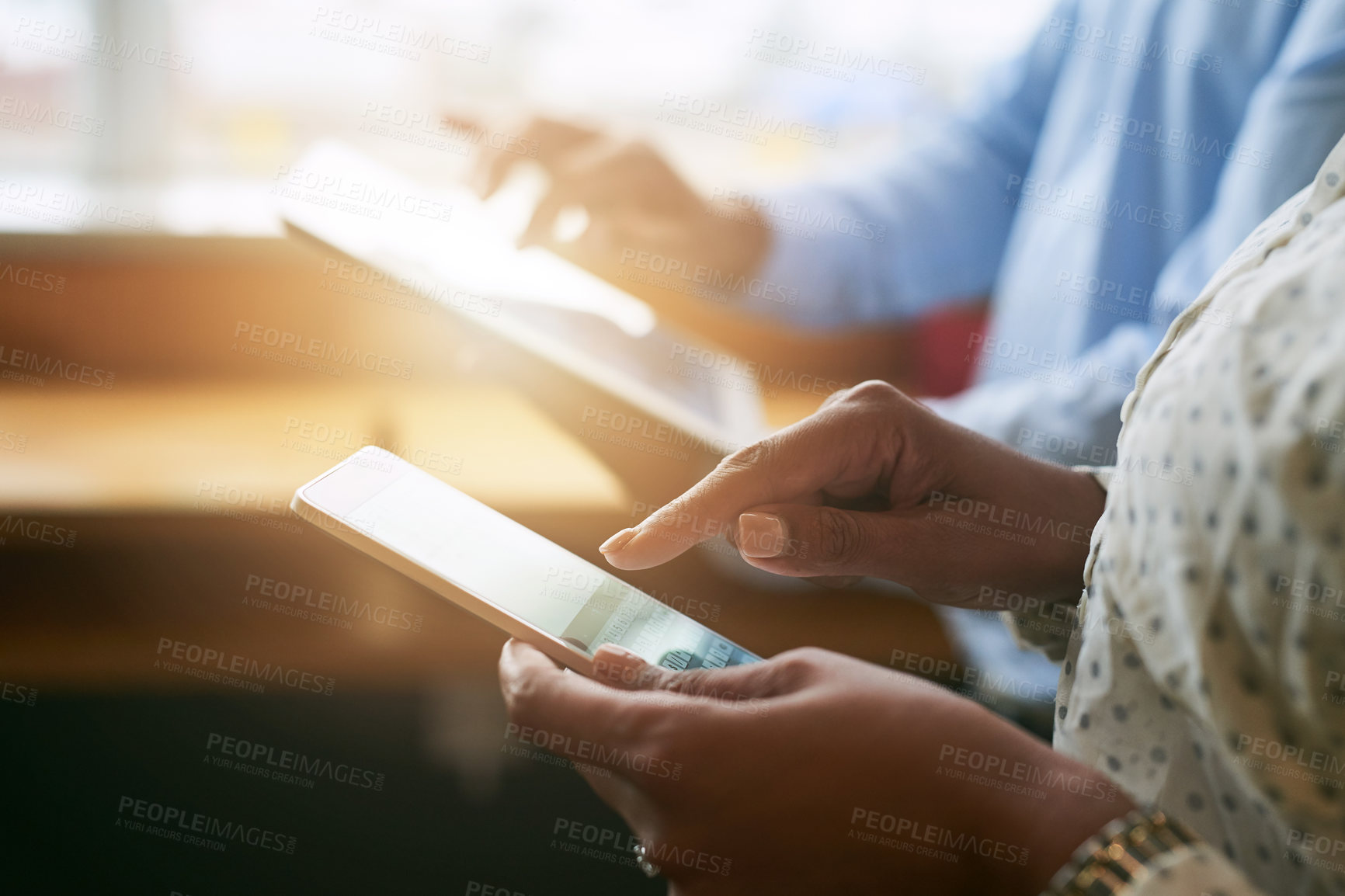 Buy stock photo Closeup shot of two unrecognisable businesspeople using digital devices in an office