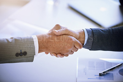 Buy stock photo Cropped shot of two unidentifiable businessmen shaking hands in the boardroom