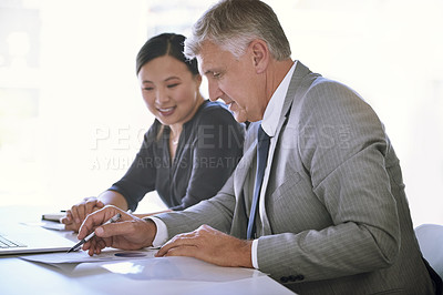 Buy stock photo Shot of a team of businesspeople meeting at a table in the boardroom