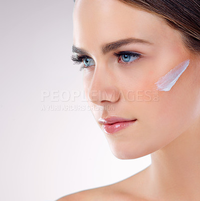 Buy stock photo Face cream, thinking or model with skincare in studio on white background for foundation, glow or shine. Facial lotion, girl model or woman with sunscreen, beauty idea or cosmetics results in closeup